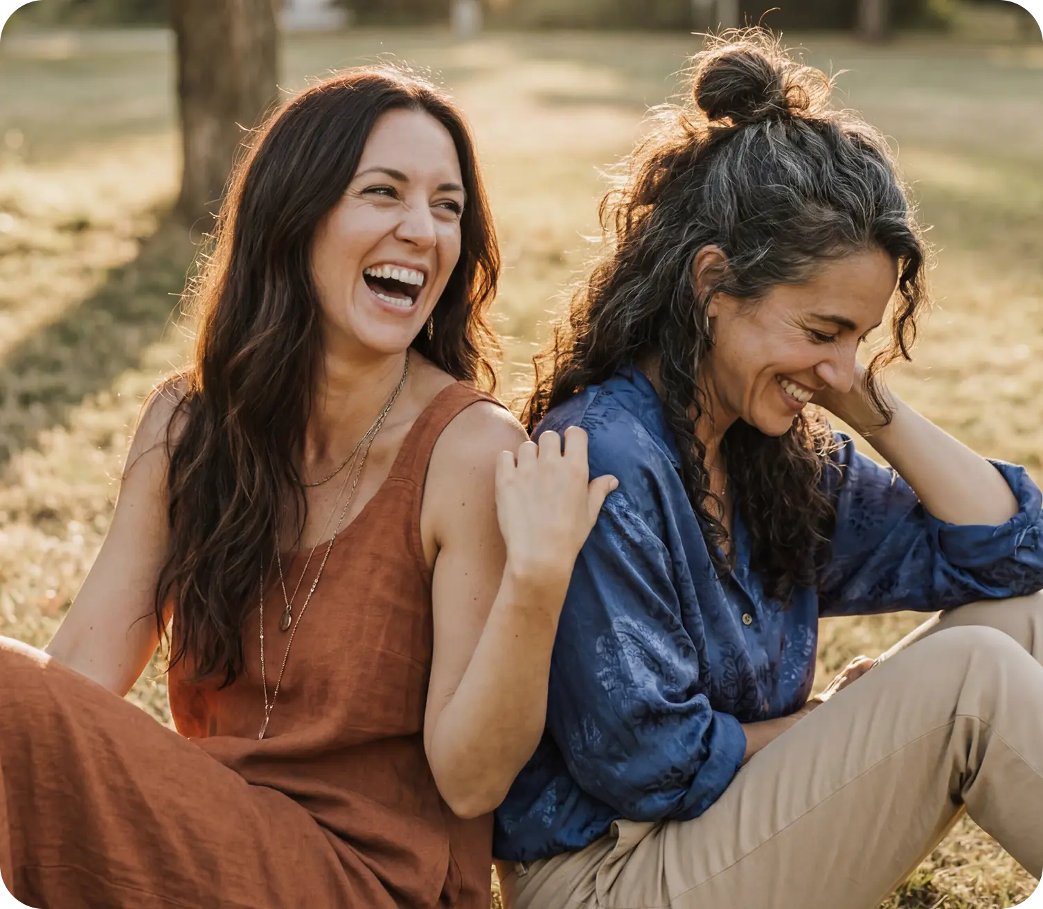 Two women laughing together outdoors