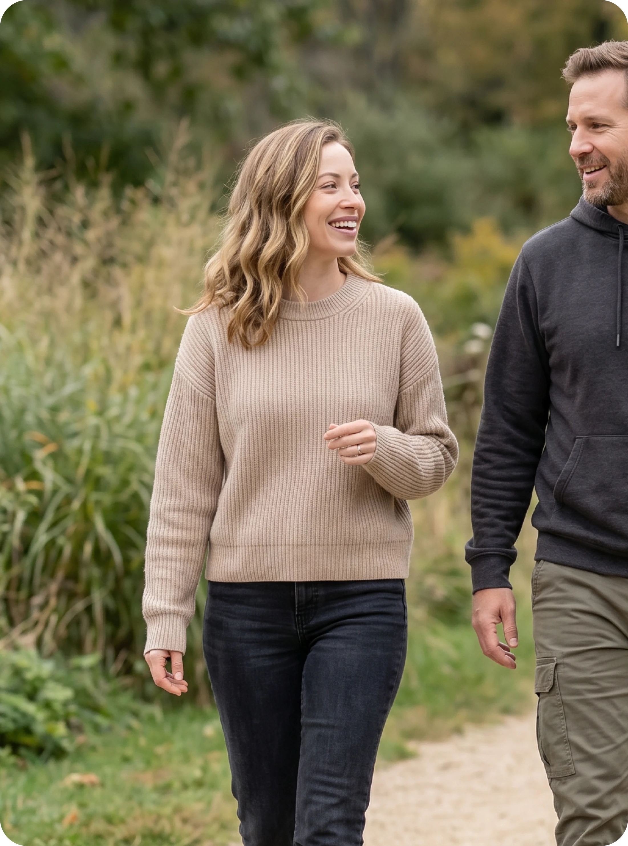 Woman walking outdoors in a park, smiling