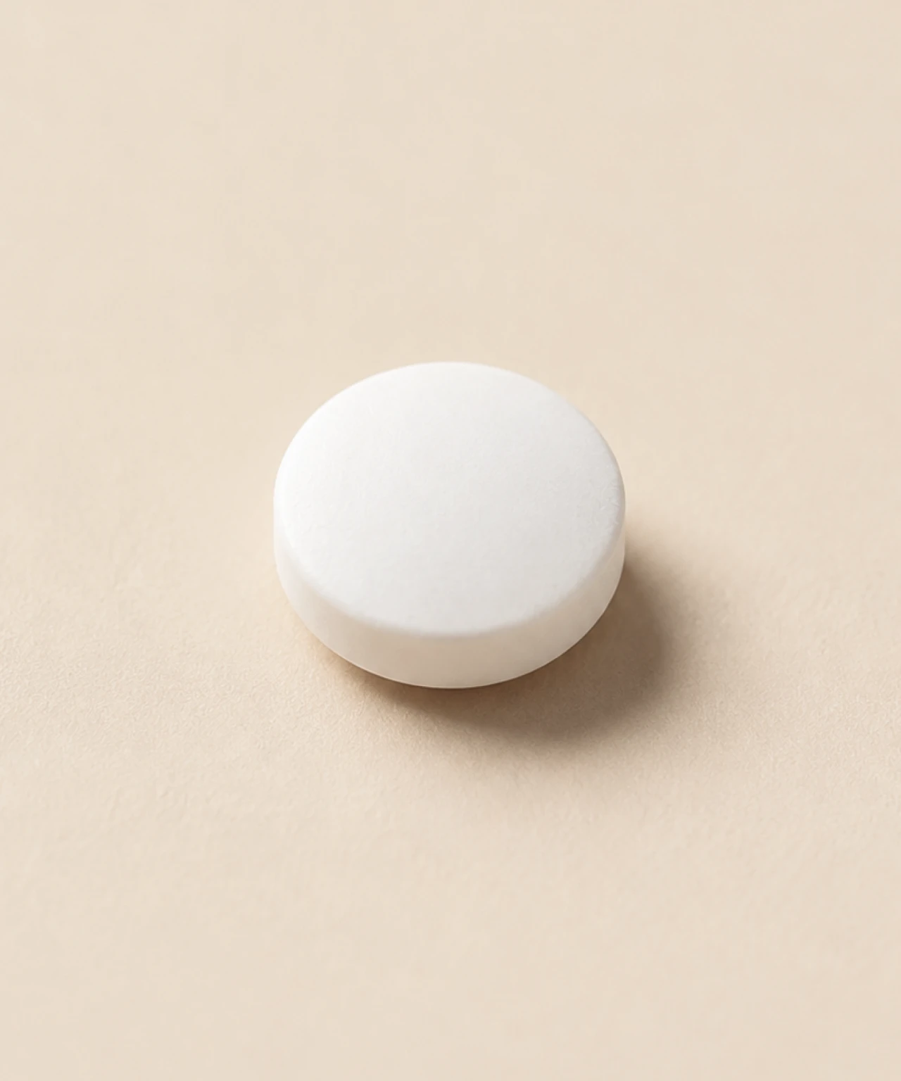 Close-up of a round white tablet